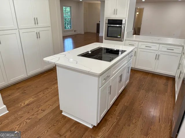 a kitchen with a sink cabinets and window