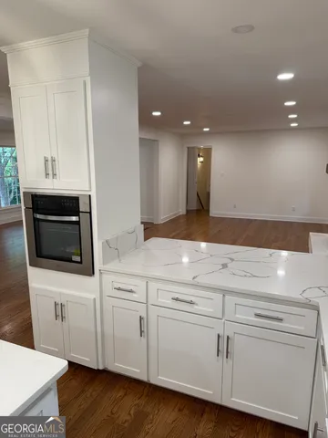 a kitchen with a sink cabinets and a window