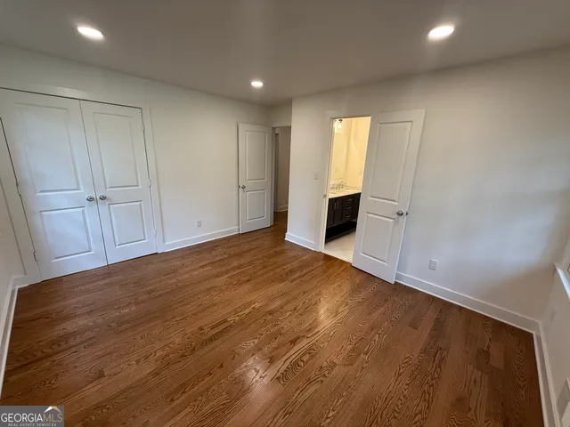 a bathroom with a granite countertop sink a mirror and shower