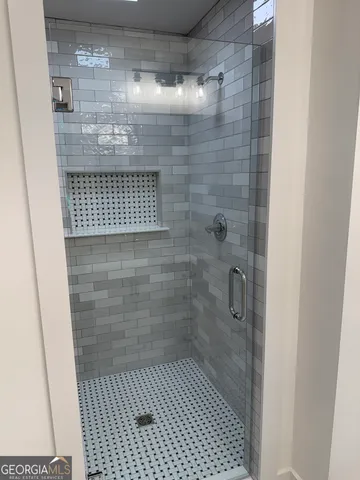 an empty room with wooden floor and a window