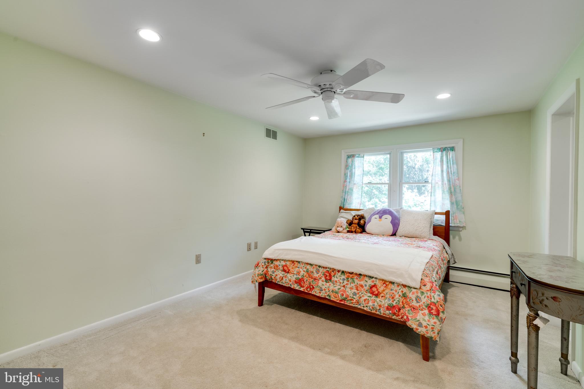 1501 Mt Pleasant Road Villanova, PA 19085 - Photo 31 of 49 a bedroom with a bed and a chandelier