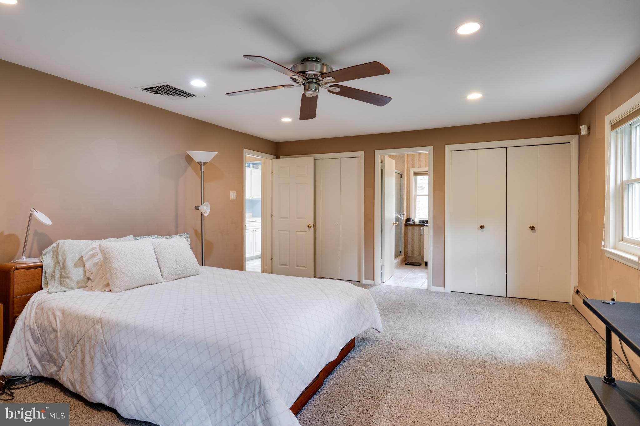 1501 Mt Pleasant Road Villanova, PA 19085 - Photo 33 of 49 a spacious bedroom with a large bed and a chandelier
