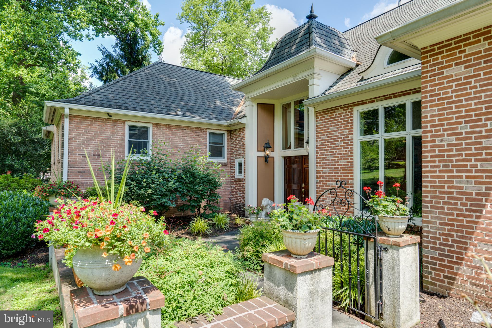 1501 Mt Pleasant Road Villanova, PA 19085 - Photo 4 of 49 a view of a house with a flower garden and flower plants