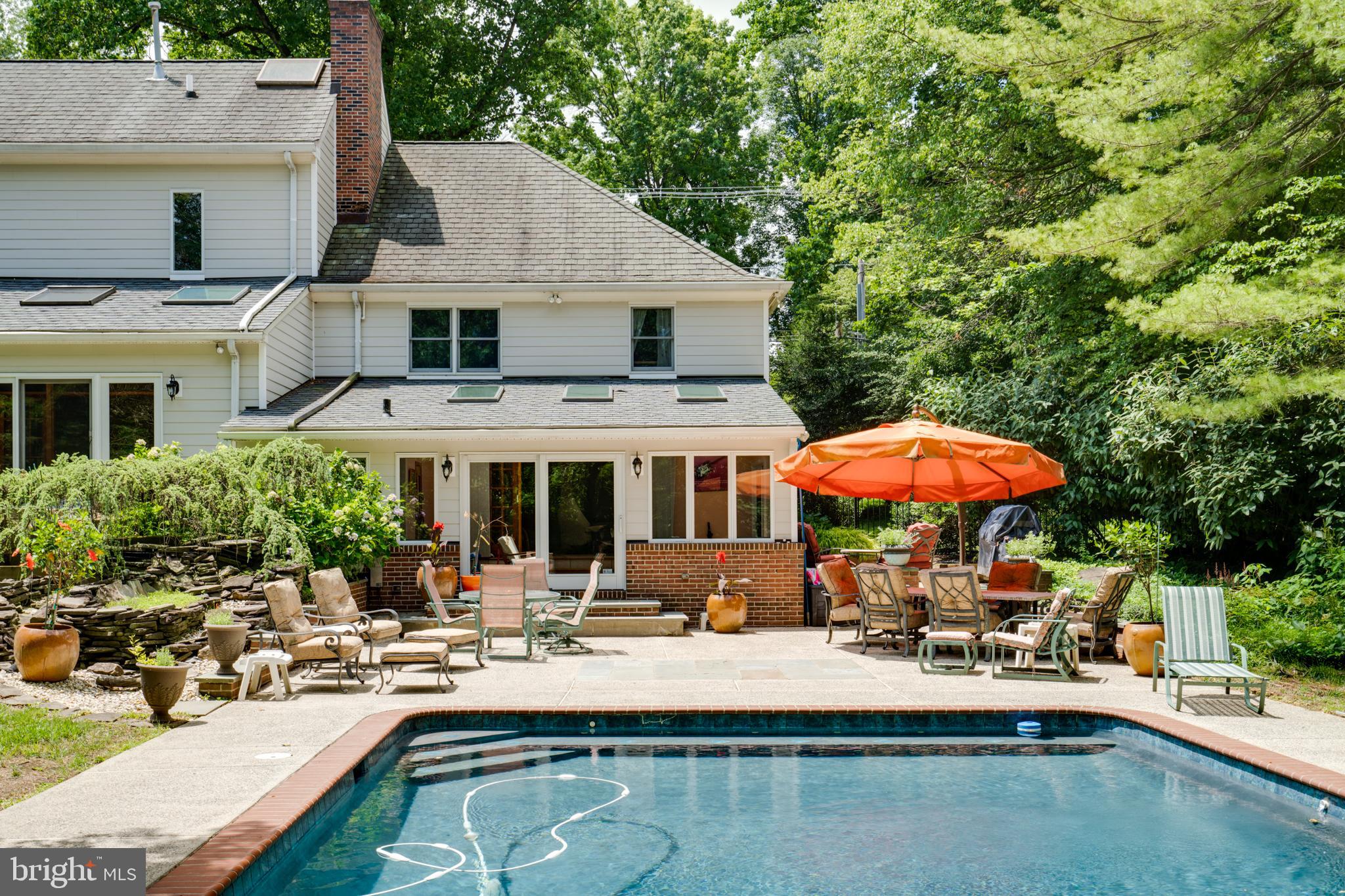 1501 Mt Pleasant Road Villanova, PA 19085 - Photo 47 of 49 a view of a house with pool and chairs under an umbrella