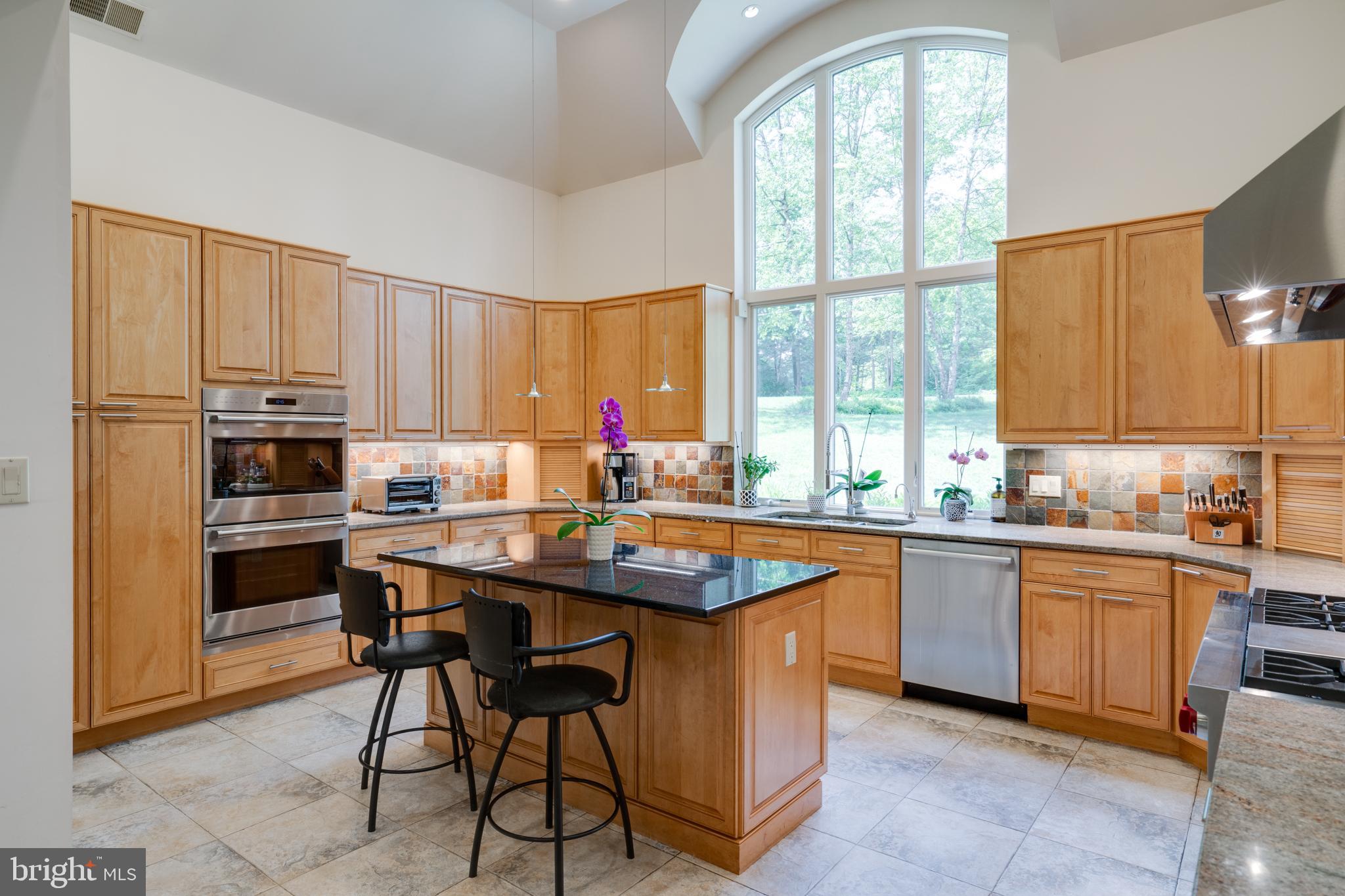 1501 Mt Pleasant Road Villanova, PA 19085 - Photo 7 of 49 a kitchen with stainless steel appliances granite countertop table chairs sink and cabinets