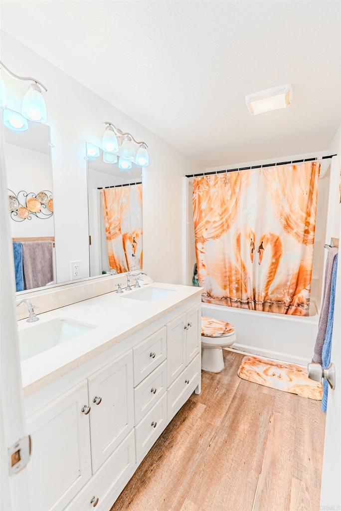 11977 Demi Lee Lane Lakeside, CA 92040 - Photo 20 of 22 a spacious bathroom with a double vanity sink toilet mirror and shower