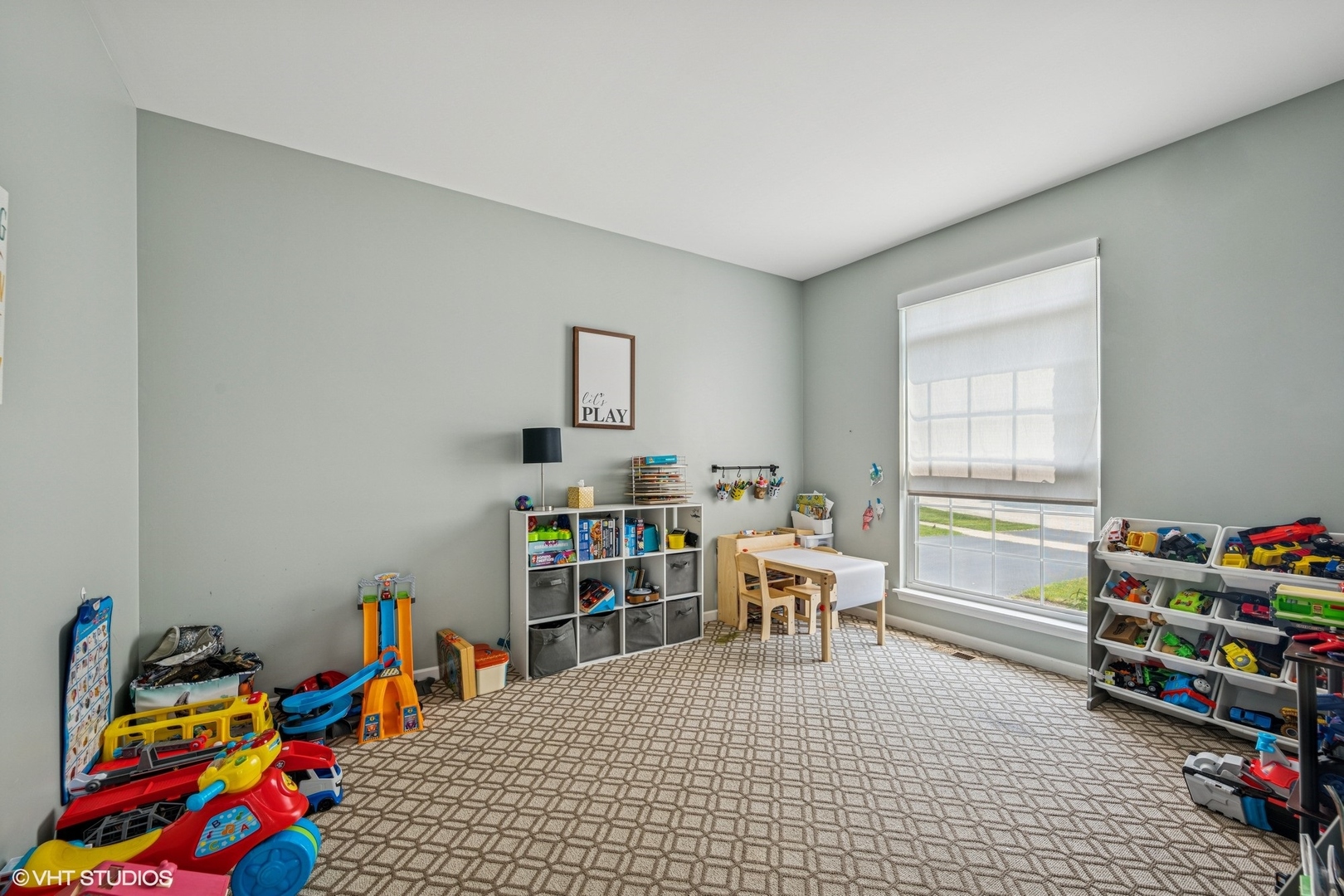 350 Sterling Circle Cary, IL 60013 - Photo 11 of 31 a living room with furniture a baby crib and a wooden floor