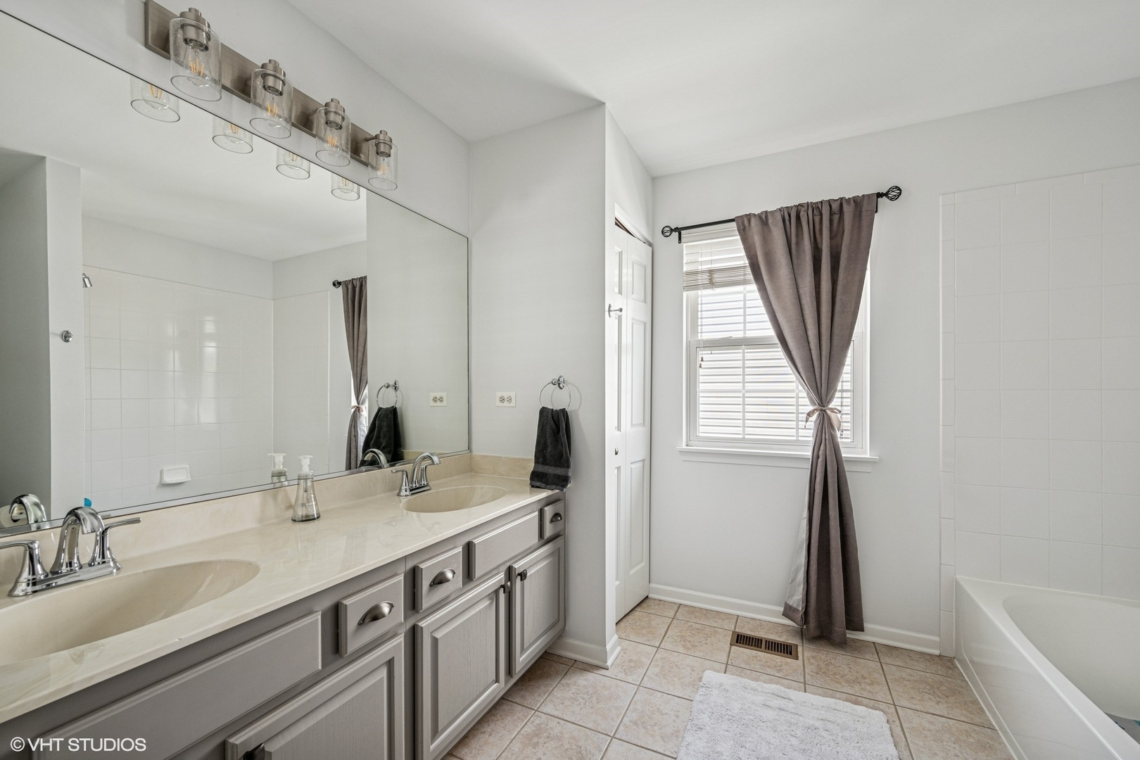 350 Sterling Circle Cary, IL 60013 - Photo 20 of 31 a spacious bathroom with a double vanity sink and a mirror