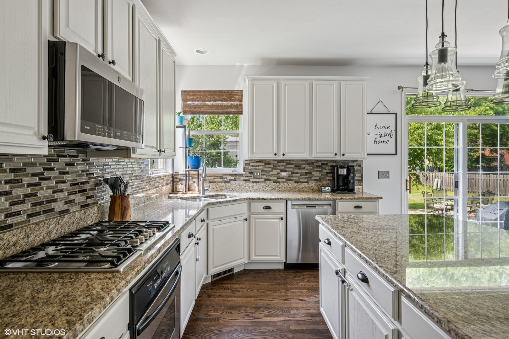 350 Sterling Circle Cary, IL 60013 - Photo 6 of 31 a kitchen with stainless steel appliances granite countertop a stove a sink dishwasher and a refrigerator