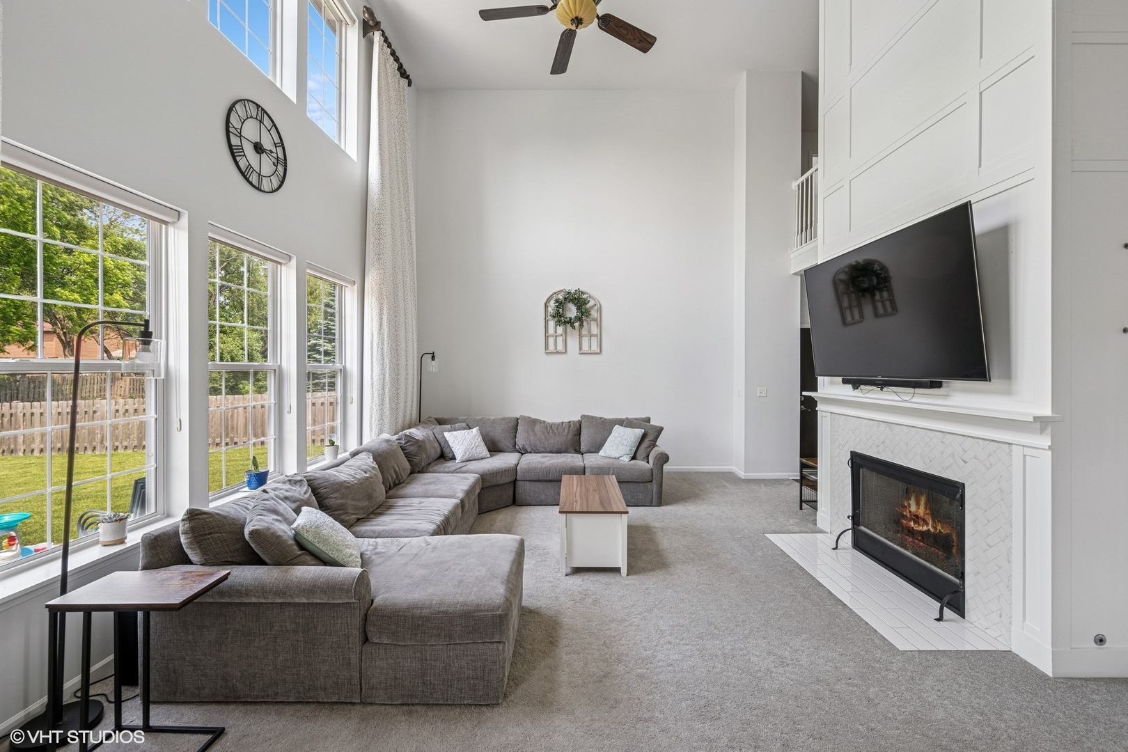 350 Sterling Circle Cary, IL 60013 - Photo 9 of 31 a living room with furniture a fireplace and a flat screen tv