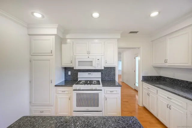 a kitchen with appliances and cabinets