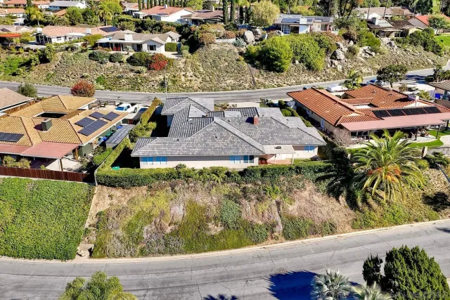 an aerial view of residential houses with outdoor space