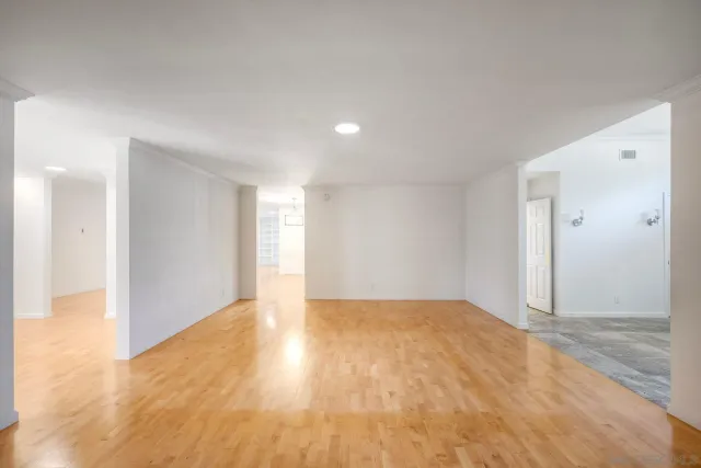 a view of an empty room and wooden floor