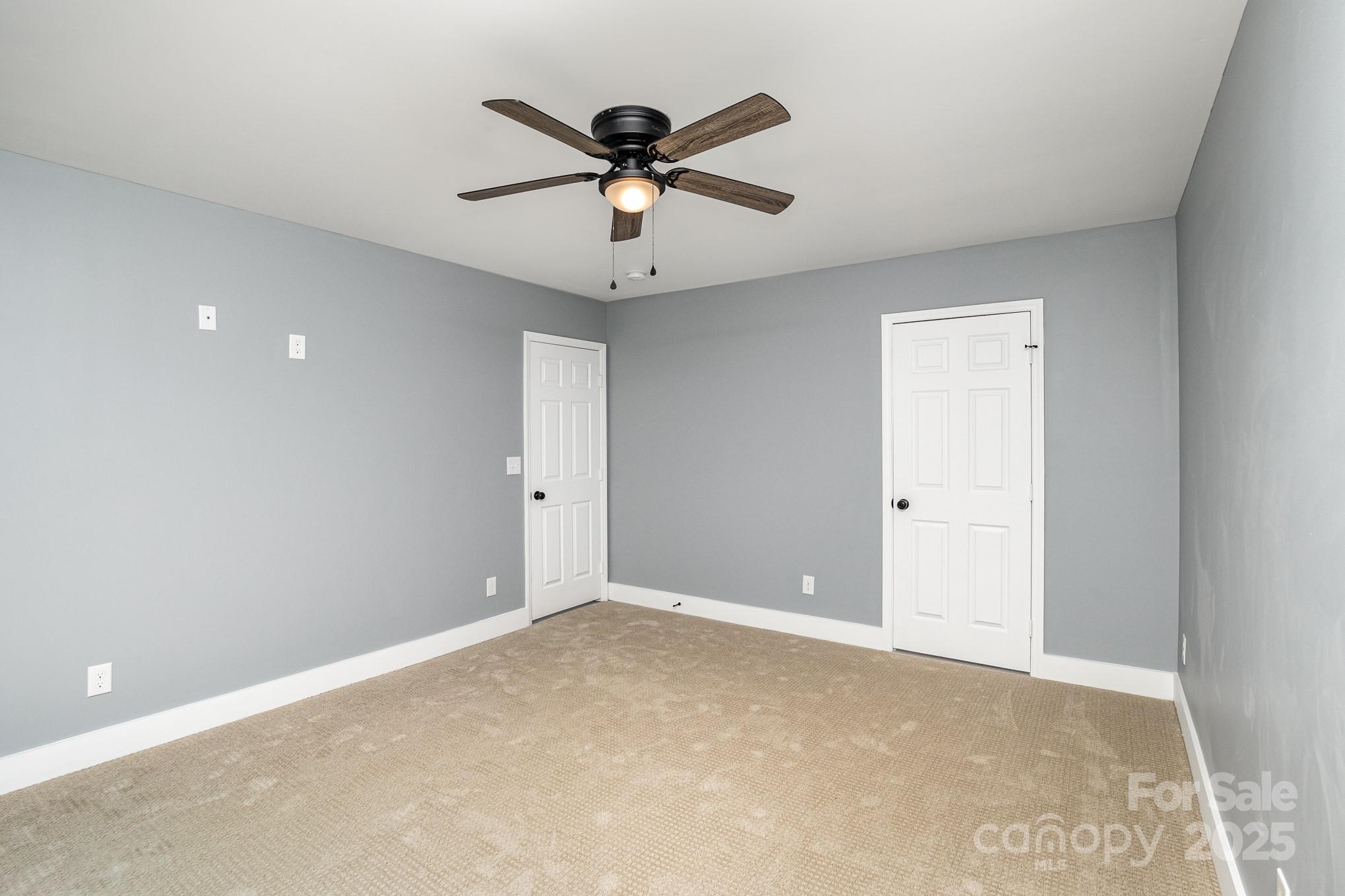 938 Valley Ridge Road Charlotte, NC 28214 - Photo 11 of 22 a view of an empty room with a ceiling fan