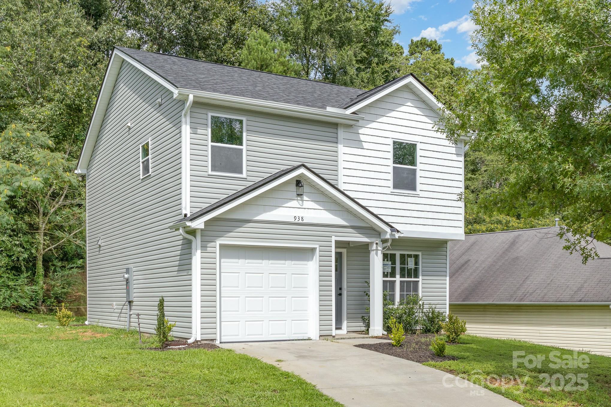 938 Valley Ridge Road Charlotte, NC 28214 - Photo 2 of 22 a front view of a house with a garden