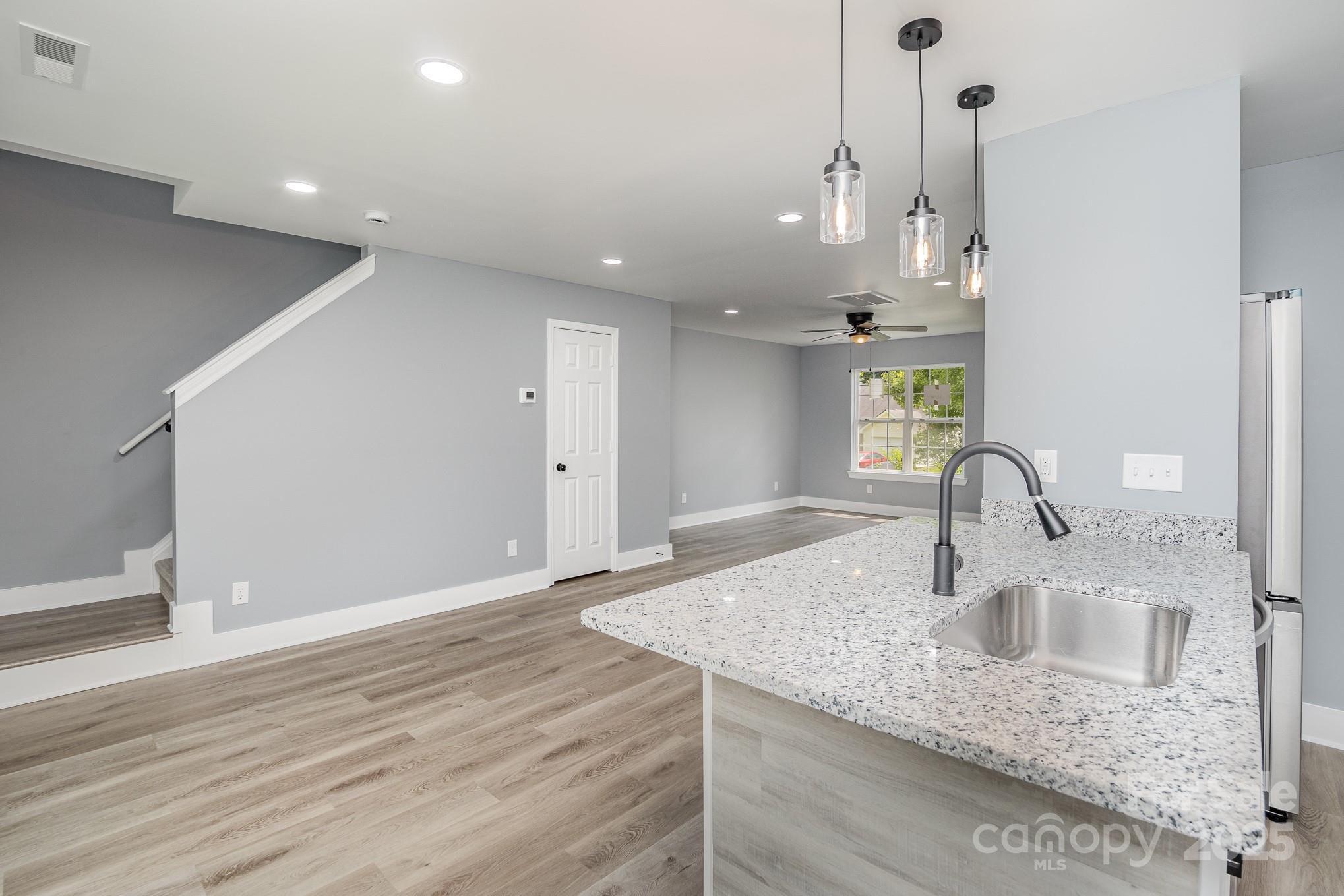 938 Valley Ridge Road Charlotte, NC 28214 - Photo 5 of 22 a kitchen with kitchen island a sink and appliances
