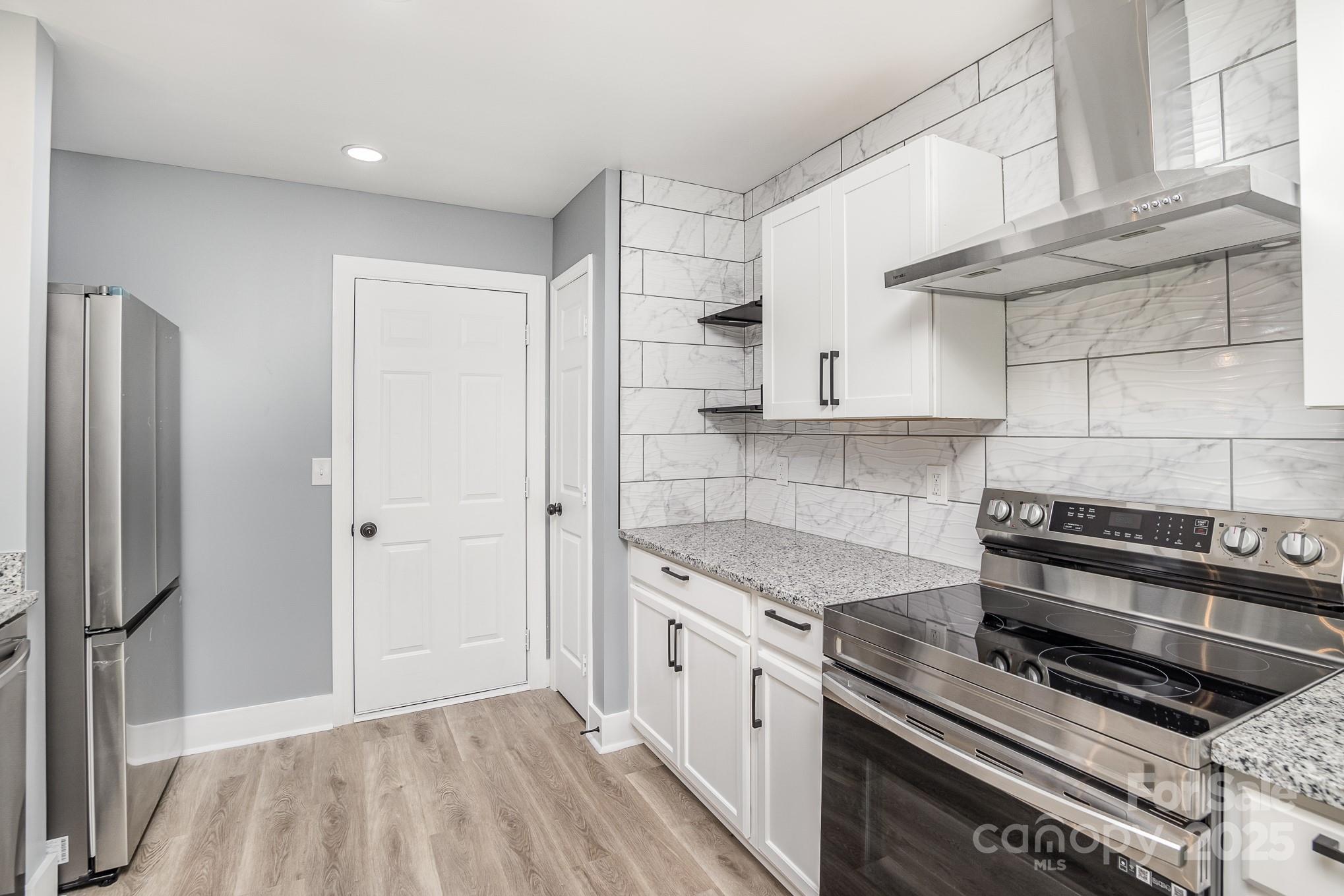 938 Valley Ridge Road Charlotte, NC 28214 - Photo 8 of 22 a kitchen with stainless steel appliances granite countertop a stove a refrigerator and a sink