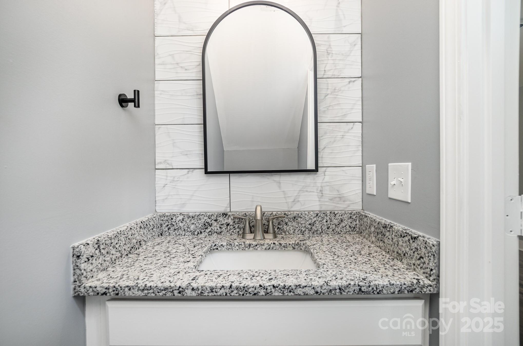 938 Valley Ridge Road Charlotte, NC 28214 - Photo 9 of 22 a bathroom with sink and mirror