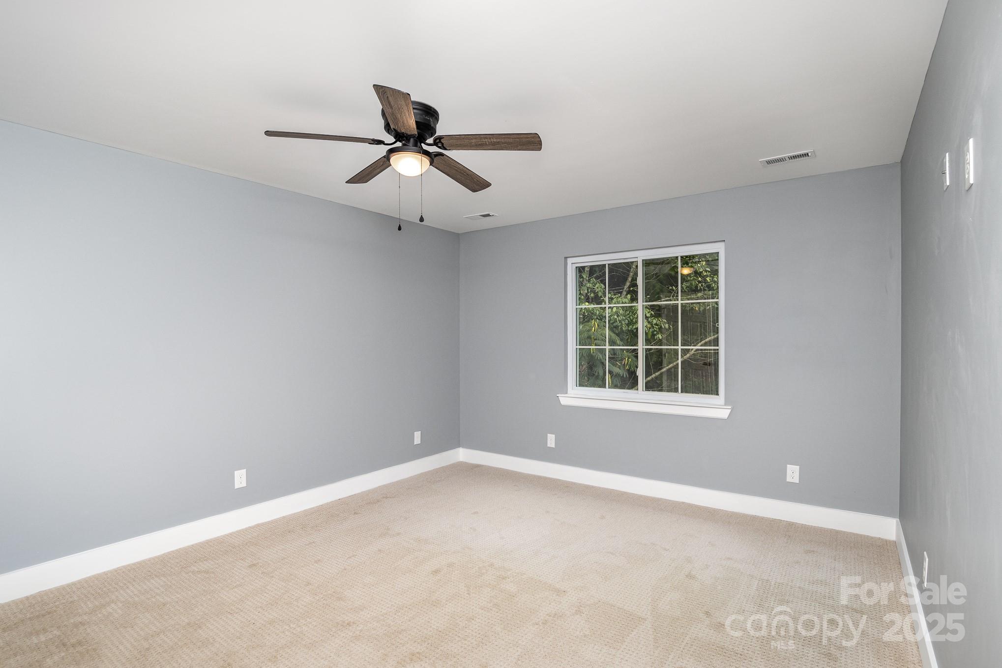 938 Valley Ridge Road Charlotte, NC 28214 - Photo 10 of 22 a view of an empty room with a window