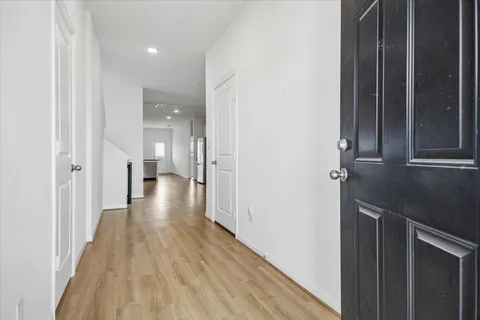 a view of a hallway with wooden floor