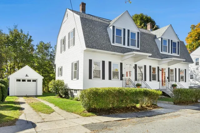 a front view of a house with a garden