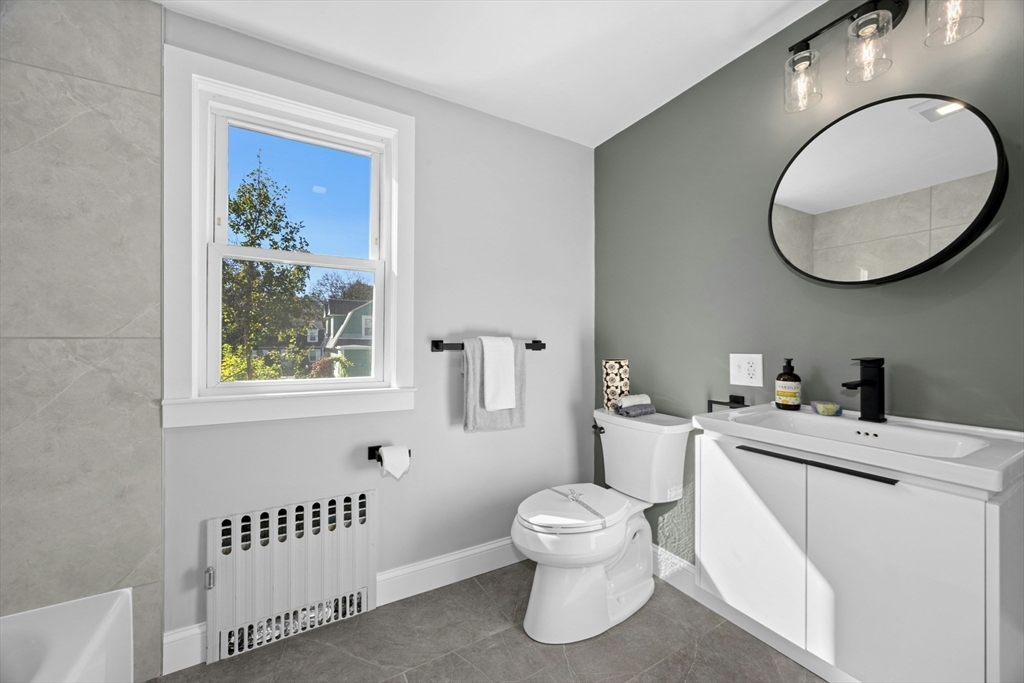 15 Arthur Street, Unit 15 Maynard, MA 01754 - Photo 17 of 21 a bathroom with a toilet a sink and a mirror