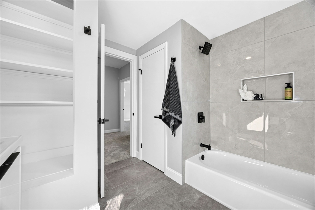 15 Arthur Street, Unit 15 Maynard, MA 01754 - Photo 18 of 21 a bath room with a bath tub and a shower