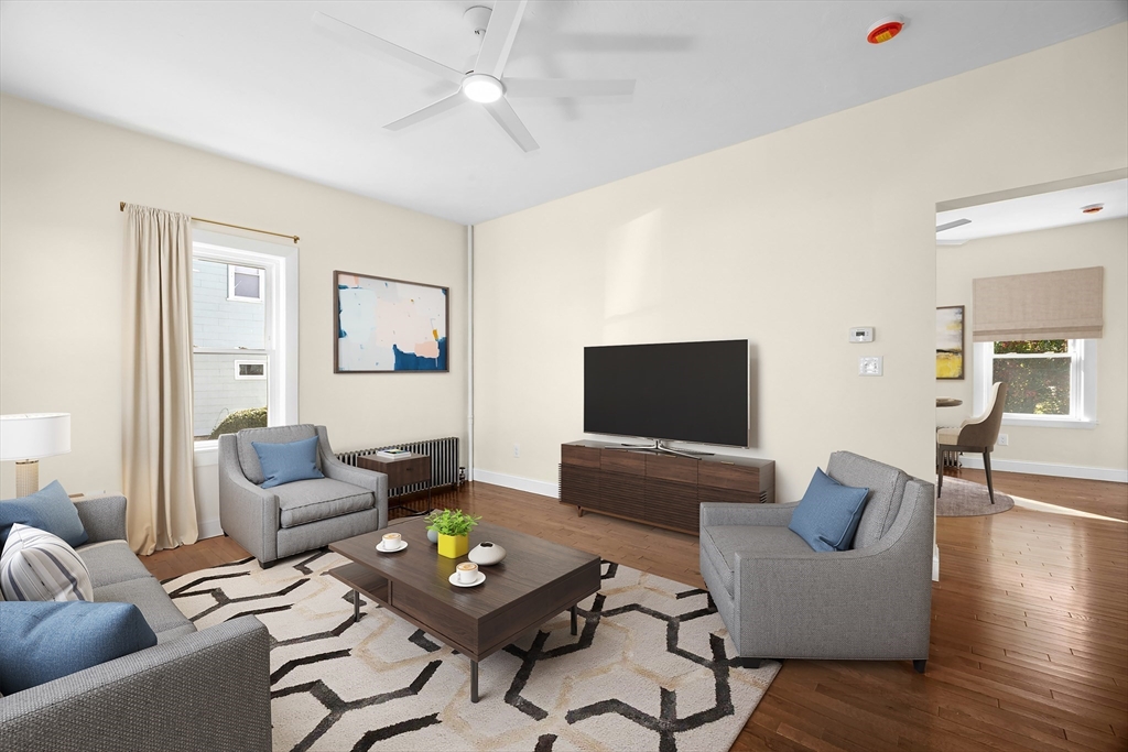 15 Arthur Street, Unit 15 Maynard, MA 01754 - Photo 3 of 21 a living room with furniture and a flat screen tv