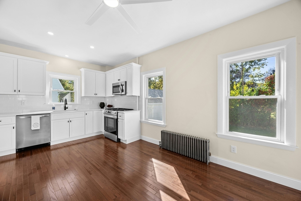 15 Arthur Street, Unit 15 Maynard, MA 01754 - Photo 6 of 21 a kitchen with wooden floors and white cabinets