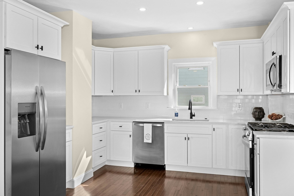 15 Arthur Street, Unit 15 Maynard, MA 01754 - Photo 8 of 21 a kitchen with white cabinets and stainless steel appliances