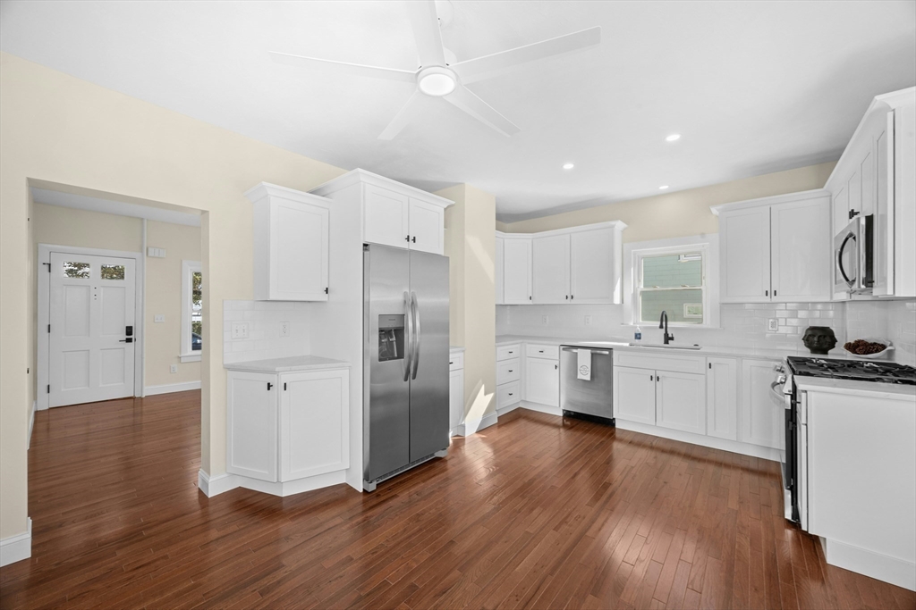 15 Arthur Street, Unit 15 Maynard, MA 01754 - Photo 9 of 21 a kitchen with white cabinets and stainless steel appliances