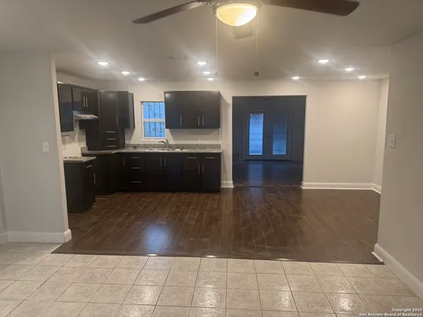 a view of a livingroom with wooden floor and a window