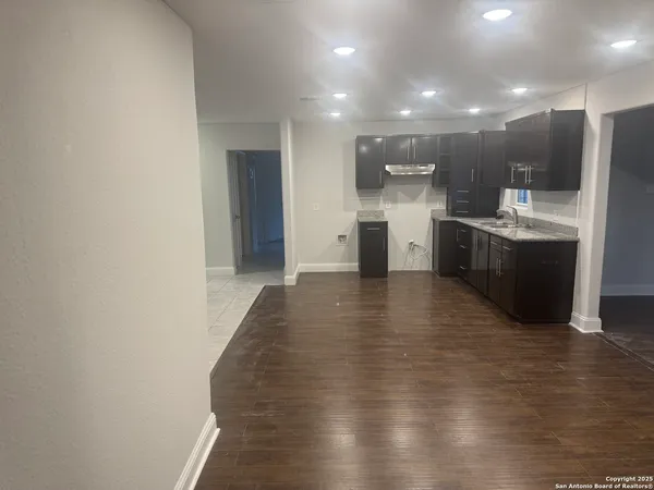 a view of a kitchen with stainless steel appliances a refrigerator