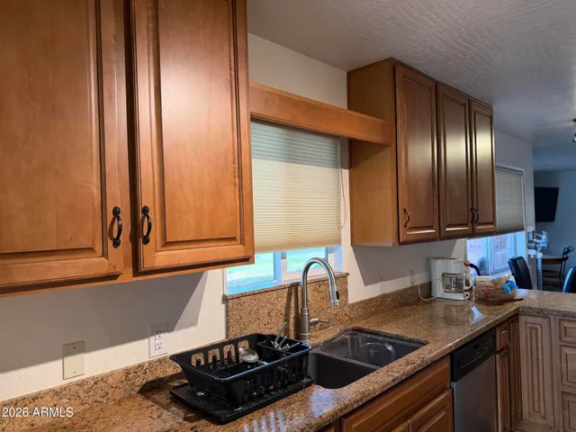 a kitchen with a sink and a stove top oven