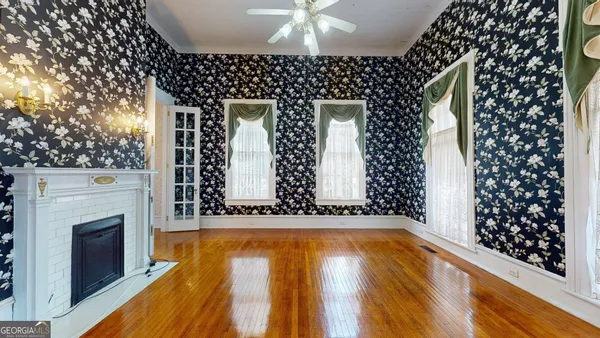 a view of empty room with window and chandelier