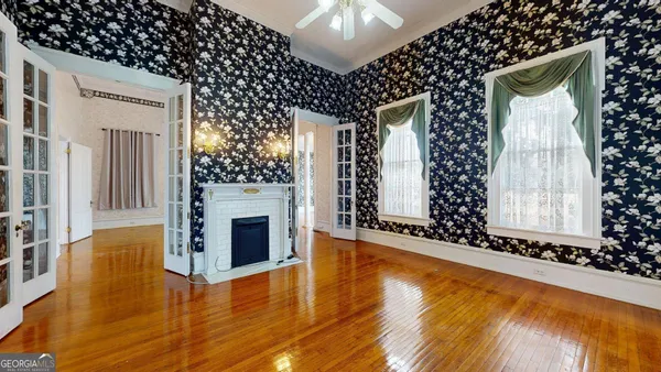 a view of a livingroom with furniture a fireplace and wooden floor