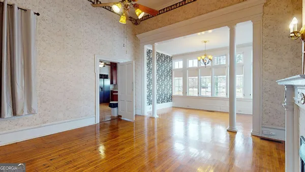 a kitchen with stainless steel appliances granite countertop a sink cabinets and wooden floor