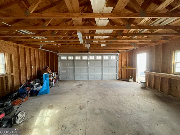 a view of a hallway with wooden floor fireplace and windows