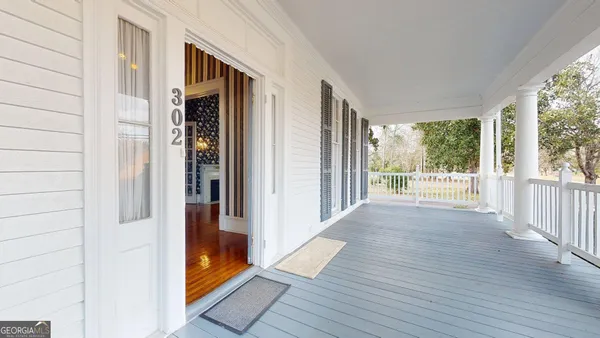 a view of a livingroom with wooden floor and a fireplace