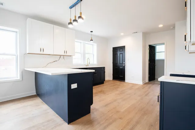 a kitchen with stainless steel appliances granite countertop a sink counter space and a window