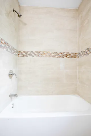 a bathroom with a bathtub and a shower