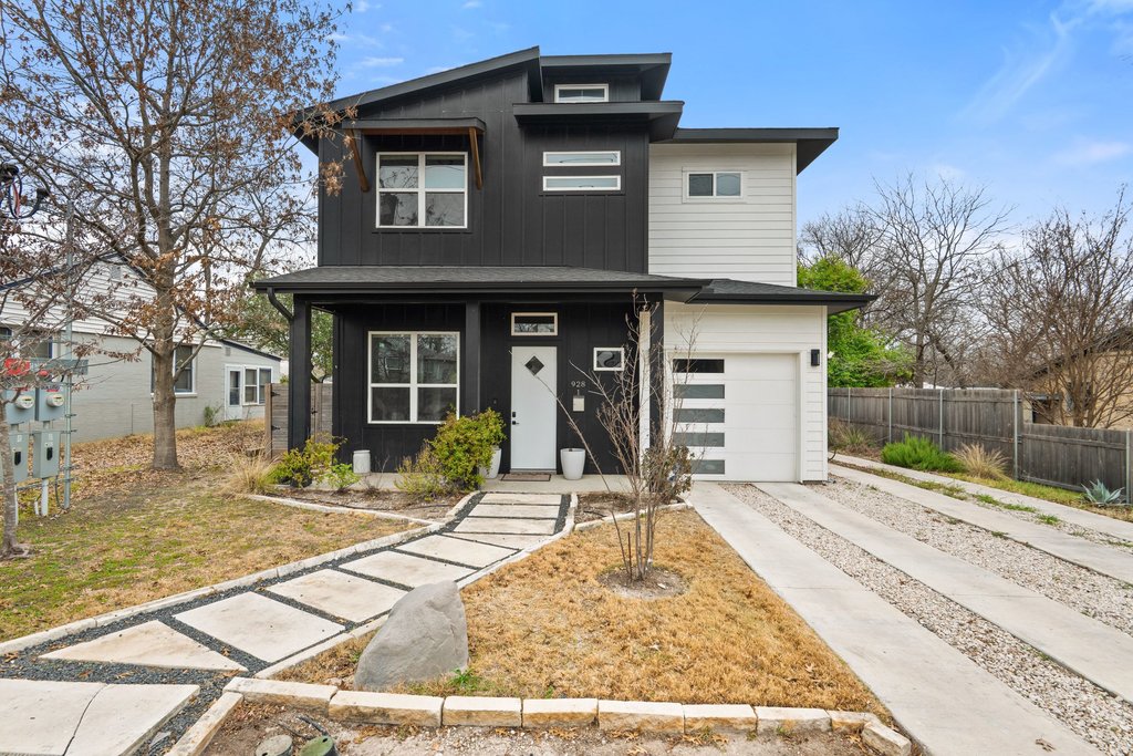 928 East 53rd 1/2 Street, Unit 1 Austin, TX 78751 - Photo 1 of 40 Modern home featuring an attached garage, covered porch, board and batten siding, and driveway