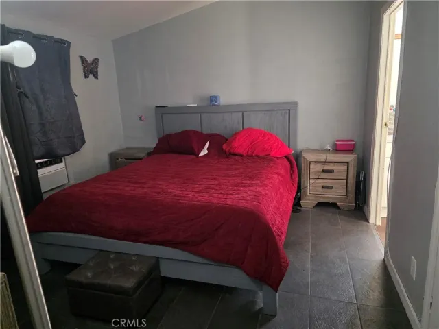 a bed sitting in a bedroom next to a window