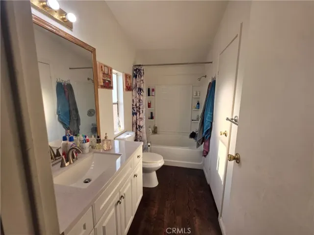 a bathroom with a double vanity sink toilet and shower