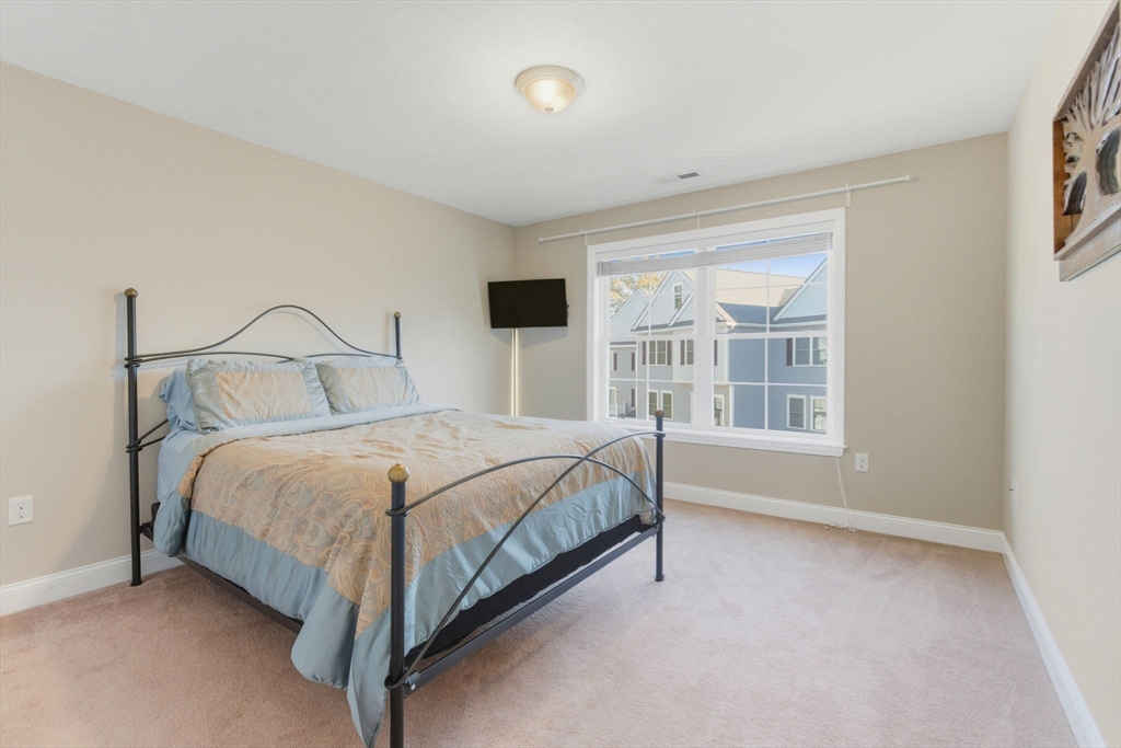 66 Compass Point, Unit 66 North Andover, MA 01845 - Photo 34 of 42 a bed sitting in a bedroom next to a window