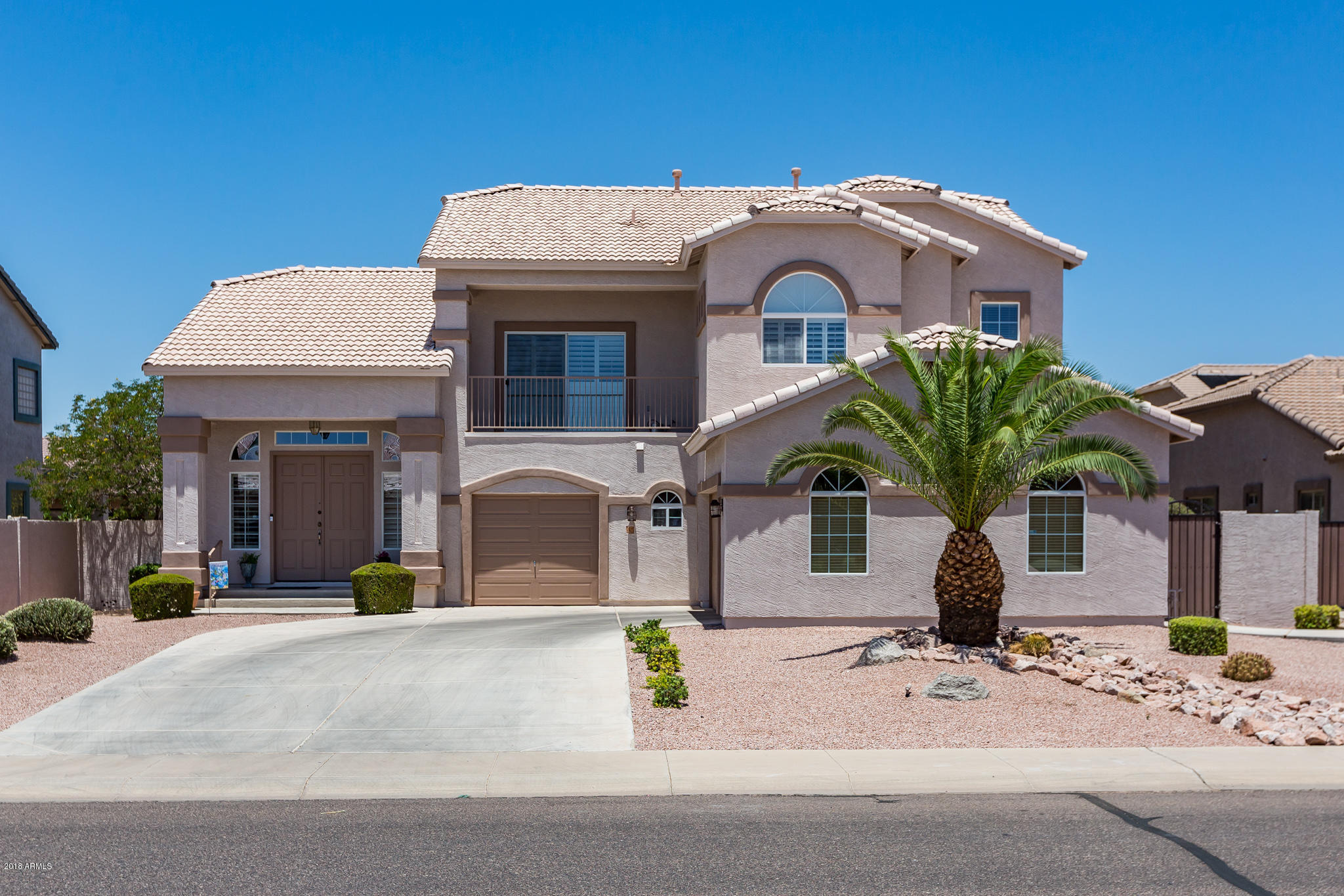 3744 East Del Rio Street Gilbert, AZ 85295 - Photo 1 of 32 a front view of a house with a garden