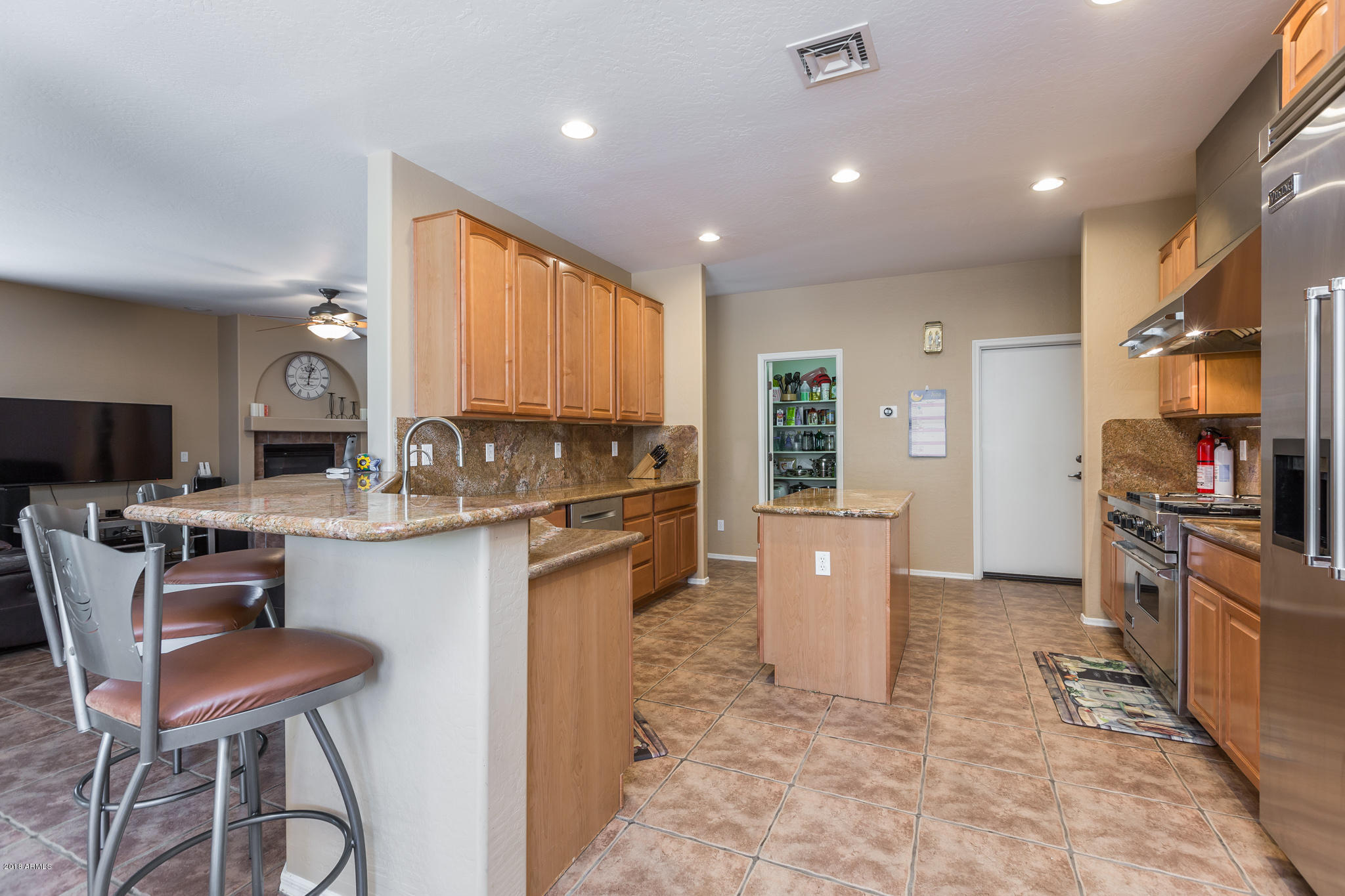 3744 East Del Rio Street Gilbert, AZ 85295 - Photo 11 of 32 a kitchen with stainless steel appliances granite countertop a refrigerator stove top oven a sink and dishwasher