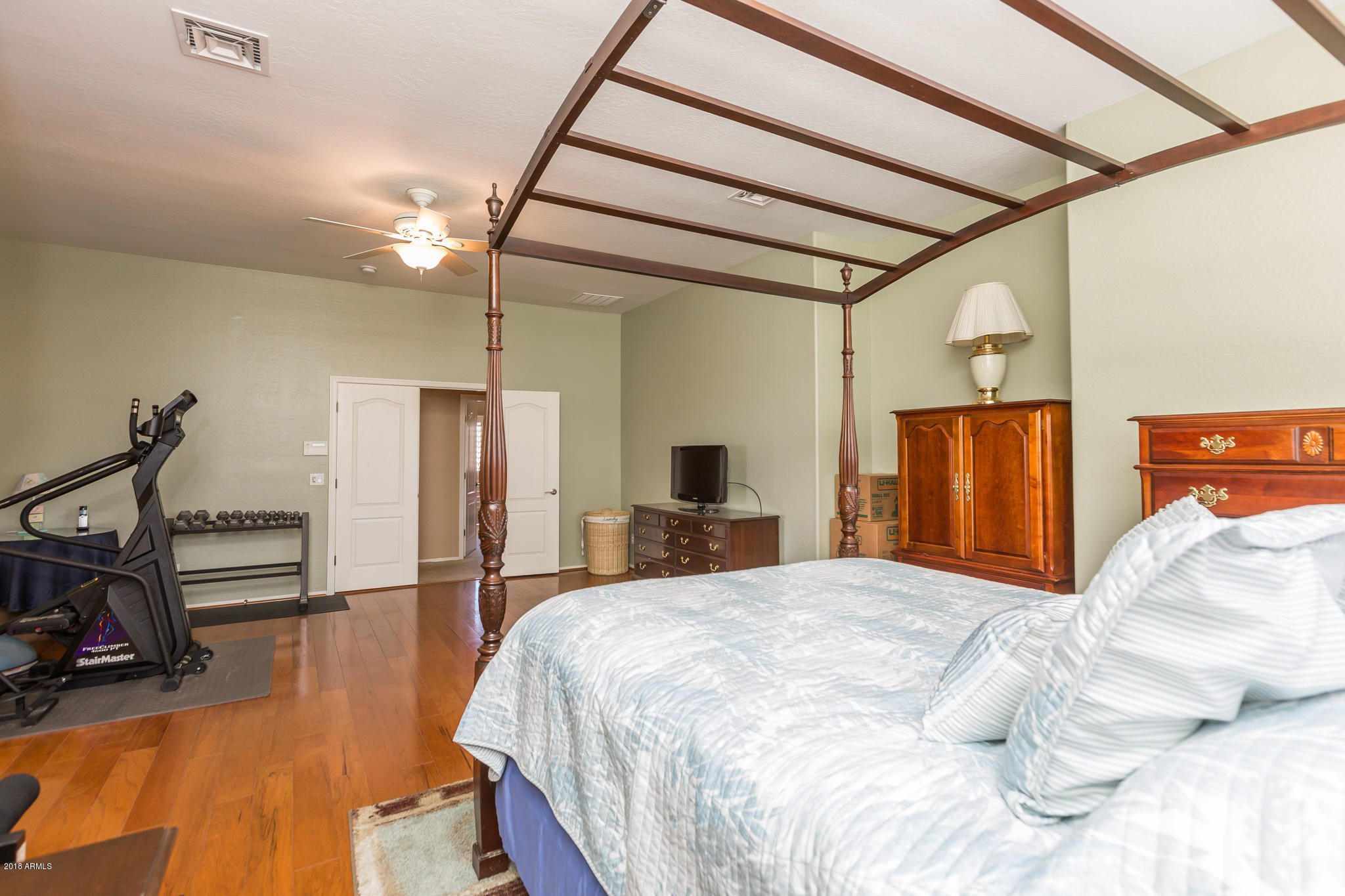 3744 East Del Rio Street Gilbert, AZ 85295 - Photo 15 of 32 a bedroom with a bed and wooden floor