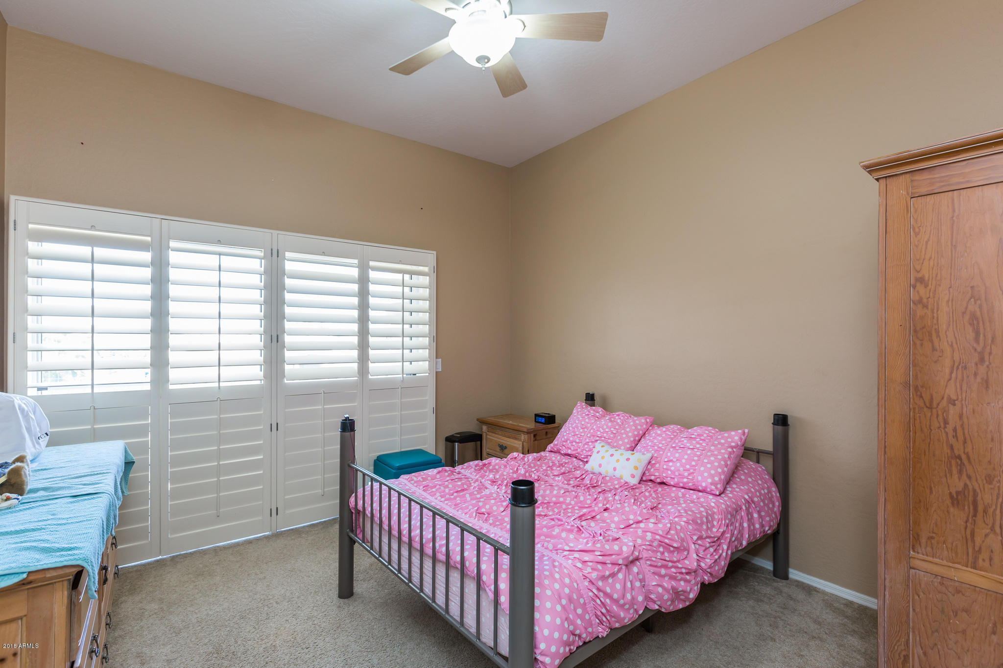 3744 East Del Rio Street Gilbert, AZ 85295 - Photo 20 of 32 a bedroom with a bed and a chandelier
