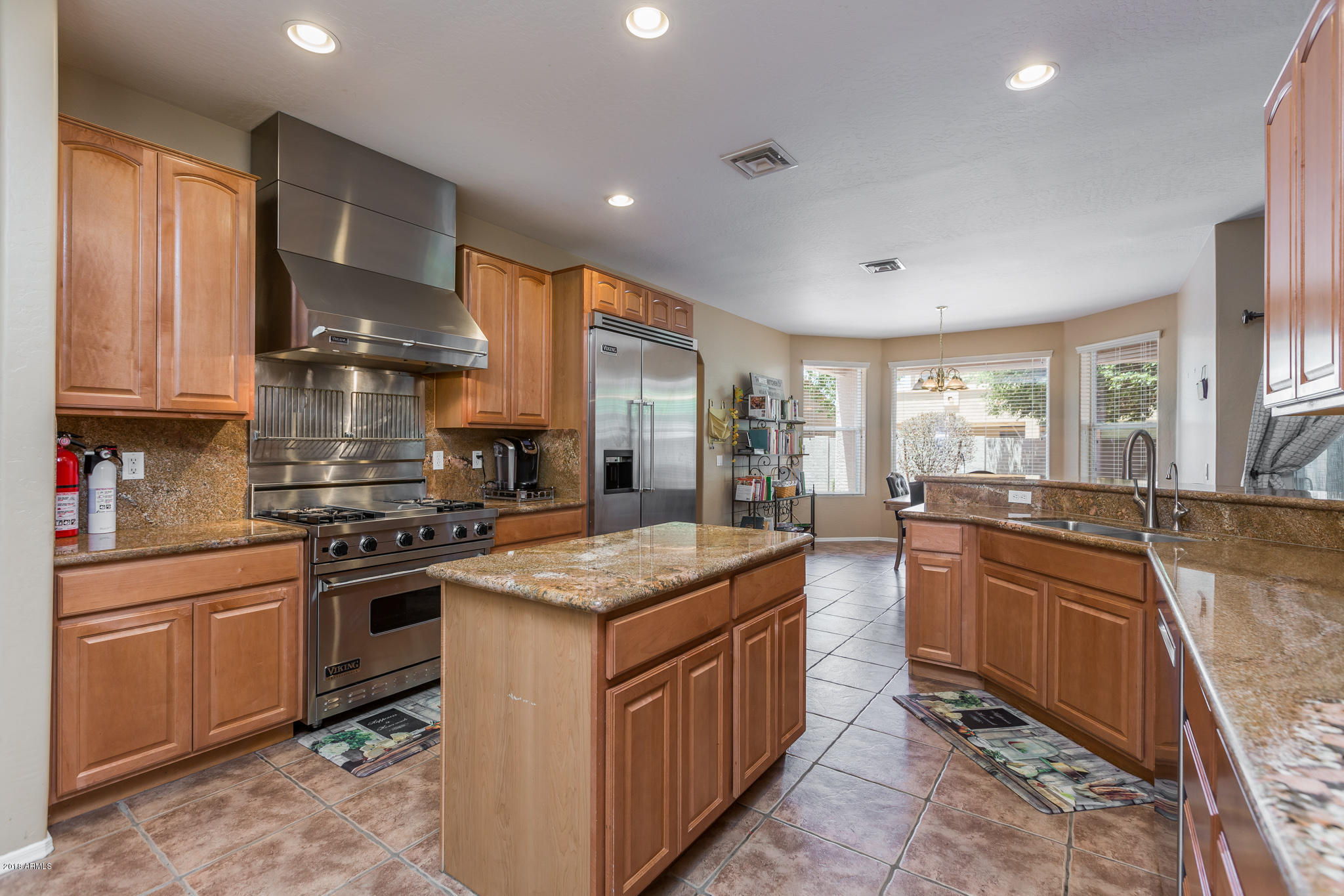 3744 East Del Rio Street Gilbert, AZ 85295 - Photo 9 of 32 a kitchen with a stove top oven sink and cabinets